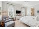 Bright main bedroom with sitting area, large windows, ceiling fan, and ensuite bathroom access at 301 Center St, Mount Pleasant, SC 29464