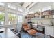 Bright and airy home office featuring a vaulted ceiling, built-in shelving, and backyard views at 301 Center St, Mount Pleasant, SC 29464