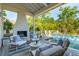 Covered patio with outdoor fireplace, comfortable seating, and a view of the private pool at 301 Center St, Mount Pleasant, SC 29464