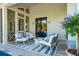 Inviting covered patio with stylish seating area and a view of the outdoor landscape at 301 Center St, Mount Pleasant, SC 29464