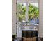 View through open doors to outdoor seating area with palm trees in the background, bringing the outdoors in at 301 Center St, Mount Pleasant, SC 29464