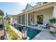 Backyard pool with screened-in porch, comfortable seating, and lush landscaping at 301 Center St, Mount Pleasant, SC 29464