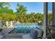 Scenic view of a pool featuring decorative tile and water fountains, surrounded by lush greenery at 301 Center St, Mount Pleasant, SC 29464