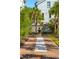 Charming brick walkway with white gravel accents leading to a home with lush greenery and a fountain at 301 Center St, Mount Pleasant, SC 29464