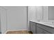 Bright bathroom featuring double sink vanity with gray cabinets and shower with glass door at 301 Watersglen Dr, Summerville, SC 29486