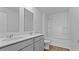 Well-lit bathroom with double vanity, white countertops, toilet, and shower-tub combo at 301 Watersglen Dr, Summerville, SC 29486