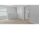 View of an upstairs bedroom with plush carpeting, adjacent to an open doorway and large window at 301 Watersglen Dr, Summerville, SC 29486