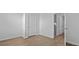 Bright bedroom with wood-look flooring, white walls, and natural light from doorway at 301 Watersglen Dr, Summerville, SC 29486