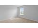 Bright bedroom with neutral carpet and walls, illuminated by a large window at 301 Watersglen Dr, Summerville, SC 29486
