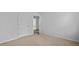 Bright bedroom featuring neutral walls and carpet, and a doorway leading to another room at 301 Watersglen Dr, Summerville, SC 29486