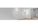 Living room with two windows overlooking the yard, hardwood-style floors, and fresh paint at 301 Watersglen Dr, Summerville, SC 29486