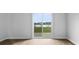 Serene view through sliding glass doors overlooking a tranquil lake and green space at 301 Watersglen Dr, Summerville, SC 29486