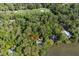 Aerial view of waterfront home surrounded by lush greenery and bordering the golf course at 3052 Seabrook Island Rd, Seabrook Island, SC 29455
