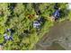 Aerial view of a home nestled amongst lush greenery near tranquil waterways at 3052 Seabrook Island Rd, Seabrook Island, SC 29455