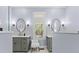 Double vanity bathroom with neutral colored cabinets, matching sconces, and framed circular mirrors at 3052 Seabrook Island Rd, Seabrook Island, SC 29455