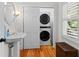 Bathroom features a pedestal sink, modern washer and dryer, and shuttered windows at 3052 Seabrook Island Rd, Seabrook Island, SC 29455