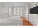 Bedroom features custom built-ins, hardwood floors, and views of the backyard at 3052 Seabrook Island Rd, Seabrook Island, SC 29455