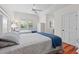 Bedroom with two twin beds, hardwood floors, and shuttered windows at 3052 Seabrook Island Rd, Seabrook Island, SC 29455
