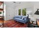 Cozy bedroom offers a comfortable blue sofa, a ceiling fan, and plenty of natural light from the large windows at 3052 Seabrook Island Rd, Seabrook Island, SC 29455