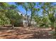 Traditional style home features a large covered front porch and dormer windows, nestled amongst mature trees at 3052 Seabrook Island Rd, Seabrook Island, SC 29455