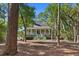 Beautifully landscaped home nestled among mature trees, offering privacy and charm at 3052 Seabrook Island Rd, Seabrook Island, SC 29455