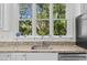 Kitchen sink in front of a large window with backyard view at 3052 Seabrook Island Rd, Seabrook Island, SC 29455