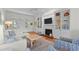 Open living room with built-in shelving, fireplace, and comfy furniture at 3052 Seabrook Island Rd, Seabrook Island, SC 29455