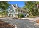Home with three-car garage and back porch overlooking wooded lot at 3052 Seabrook Island Rd, Seabrook Island, SC 29455