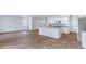 An open concept living room and kitchen area with hardwood floors and stainless steel appliances at 307 Watersglen Dr, Summerville, SC 29486