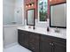Bathroom featuring a double vanity with framed mirrors, white tile, and glass-enclosed shower at 336 Trailmore Ln, Summerville, SC 29486