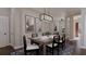 Elegant dining room with a wooden table, seating for six, a blue patterned rug, and decorative lighting at 336 Trailmore Ln, Summerville, SC 29486