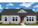 Charming single-story home with light gray siding, black roof, and a well-manicured lawn and shrubbery at 336 Trailmore Ln, Summerville, SC 29486