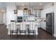 Modern kitchen with white cabinets, stainless steel appliances, quartz countertops, and bar seating at 336 Trailmore Ln, Summerville, SC 29486