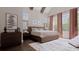 Serene bedroom featuring large windows, neutral decor, a king-sized bed, and elegant curtains at 336 Trailmore Ln, Summerville, SC 29486