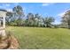 Large lush green back yard is nicely landscaped with mature trees at 4000 Saltwater Cir, Johns Island, SC 29455