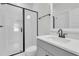 Modern bathroom with a sleek glass shower and vanity with dark fixtures at 4000 Saltwater Cir, Johns Island, SC 29455