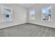 Bright bedroom featuring three windows and neutral carpeting at 4000 Saltwater Cir, Johns Island, SC 29455