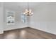 Elegant dining room with wainscoting, hardwood flooring, and modern chandelier, perfect for gatherings at 4000 Saltwater Cir, Johns Island, SC 29455