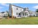 Two story home featuring a back porch, a lawn, and light gray siding at 4000 Saltwater Cir, Johns Island, SC 29455