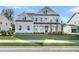 Charming two-story home featuring a covered front porch, manicured lawn and classic curb appeal at 4000 Saltwater Cir, Johns Island, SC 29455