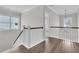 Upstairs hallway with hardwood flooring and white stair railing at 4000 Saltwater Cir, Johns Island, SC 29455