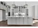 Large kitchen island with gray cabinets, stainless steel faucet and quartz countertops at 4000 Saltwater Cir, Johns Island, SC 29455