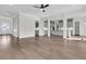 Open-concept living room with hardwood floors, gray cabinets, and a modern kitchen, ideal for entertaining at 4000 Saltwater Cir, Johns Island, SC 29455