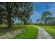 Scenic walking path through the community with views of mature trees, grassy landscapes and community swing at 4000 Saltwater Cir, Johns Island, SC 29455