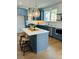 Modern kitchen featuring blue cabinets, stainless steel appliances, and a marble countertop island at 405 Oak Hammock Ct # 49, Johns Island, SC 29455