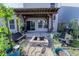 Cozy backyard featuring a pergola-covered patio and stone fire pit, perfect for outdoor gatherings and relaxation at 408 Fox Sparrow Ct, Summerville, SC 29486