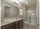 Bathroom featuring double sinks and a glass-enclosed shower at 408 Fox Sparrow Ct, Summerville, SC 29486