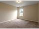 Standard carpeted bedroom with beige walls, window with blinds, and standard electrical outlets at 408 Fox Sparrow Ct, Summerville, SC 29486