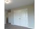 Neutral bedroom with closet doors featuring carpet flooring and a ceiling light fixture at 408 Fox Sparrow Ct, Summerville, SC 29486