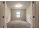 Empty bedroom with neutral carpet, window with blinds, and double doors leading to the room at 408 Fox Sparrow Ct, Summerville, SC 29486